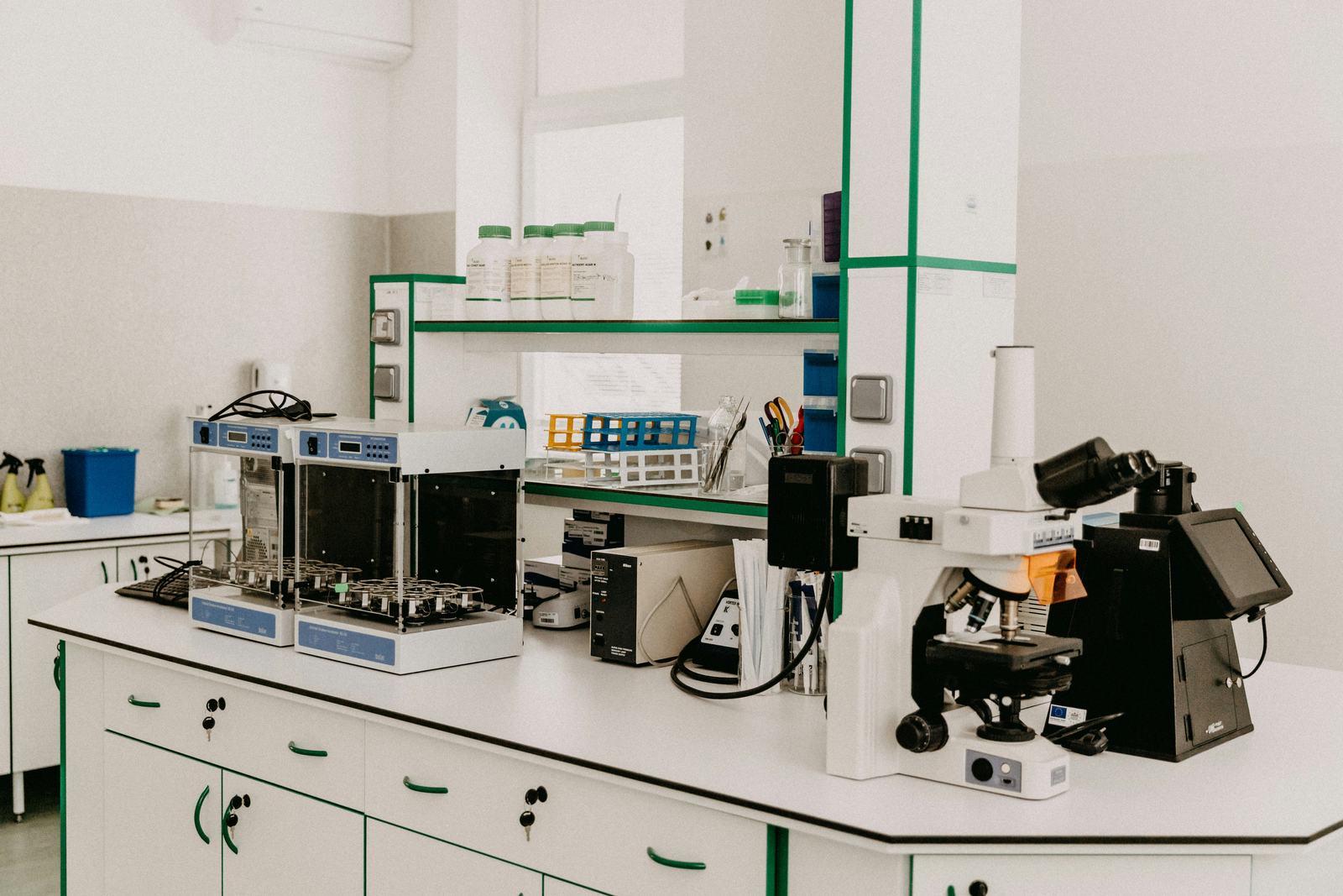 Modern laboratory bench with analytical instruments and a microscope